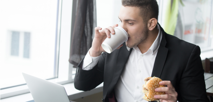 Man with cofee and burger